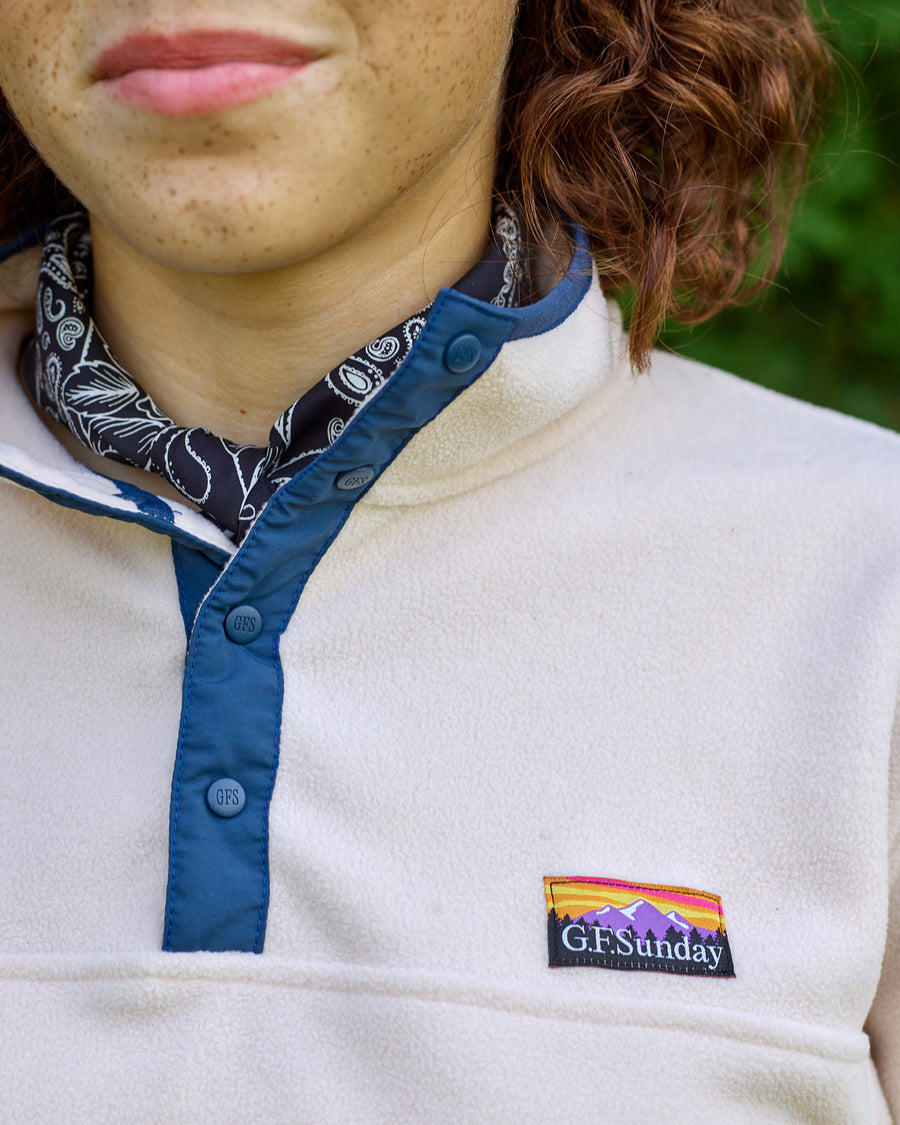 Logo stamped buttons and outdoor-inspired woven patch